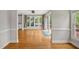 Bright living room featuring hardwood floors, large windows, and access to the outdoor deck at 100 Highfield Ave, Cary, NC 27519
