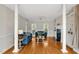 Bright living room with columns, hardwood floors, a fireplace, and comfortable blue sofas at 100 Highfield Ave, Cary, NC 27519