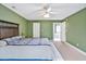 Olive main bedroom with a large bed, carpet, ceiling fan, closet and entrance to main bathroom at 100 Highfield Ave, Cary, NC 27519