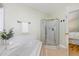 Well-maintained bathroom featuring a glass-enclosed shower, soaking tub, and tile flooring at 101 Abram Way, Clayton, NC 27520