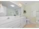 Bright bathroom with double sinks, white cabinetry, and a large mirror at 101 Abram Way, Clayton, NC 27520