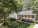 Charming single-story home with a cozy front porch and meticulously landscaped yard at 101 Abram Way, Clayton, NC 27520