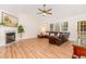 Cozy living room features a fireplace, ample natural light, vaulted ceiling, and wood laminate flooring at 101 Abram Way, Clayton, NC 27520