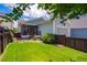Charming backyard with a screened porch, lush lawn, and privacy fence perfect for outdoor relaxation and entertainment at 104 Treywood Ln, Chapel Hill, NC 27516