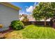 Picturesque backyard featuring green grass, lush greenery, privacy fence, and shade trees at 104 Treywood Ln, Chapel Hill, NC 27516