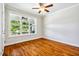 Well-lit bedroom with hardwood floors, neutral walls, and large windows that allow natural light at 104 Treywood Ln, Chapel Hill, NC 27516