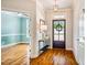Welcoming foyer featuring hardwood floors, elegant lighting, and a view into the adjacent office space at 104 Treywood Ln, Chapel Hill, NC 27516