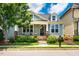 Charming light blue home featuring dormer windows, a cozy front porch, and beautifully landscaped yard at 104 Treywood Ln, Chapel Hill, NC 27516