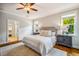 Main bedroom featuring a king bed, side tables, and a view of the landscape at 104 Treywood Ln, Chapel Hill, NC 27516