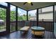 Relaxing screened porch with comfortable chaise lounge and outdoor table, perfect for leisure at 104 Treywood Ln, Chapel Hill, NC 27516