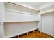 Walk-in closet providing ample storage with built-in shelving and rods above a hardwood floor at 104 Treywood Ln, Chapel Hill, NC 27516