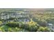 Serene community view with lush greenery and mature trees at sunset at 105 Walter Hagen Dr, Mebane, NC 27302