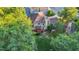 Aerial view of a beautiful home with a large backyard, deck, and mature trees at 105 Walter Hagen Dr, Mebane, NC 27302