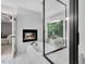Serene bathroom featuring a soaking tub, a glass shower, fireplace, and natural light from the window at 105 Walter Hagen Dr, Mebane, NC 27302