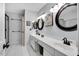 Well-lit bathroom with dual vanities, modern fixtures, framed mirrors and decorative wall art at 105 Walter Hagen Dr, Mebane, NC 27302