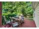 Outdoor deck area featuring a table, chairs, and greenery, perfect for relaxing and enjoying the outdoors at 105 Walter Hagen Dr, Mebane, NC 27302