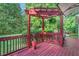 Outdoor deck featuring string lights, lush greenery, and comfortable seating at 105 Walter Hagen Dr, Mebane, NC 27302