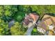 Aerial view of a traditional home with a driveway and backyard surrounded by lush trees at 105 Walter Hagen Dr, Mebane, NC 27302