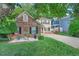 Charming home featuring a brick exterior accent, manicured lawn, and colorful landscaping in a suburban setting at 105 Walter Hagen Dr, Mebane, NC 27302