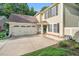 Well-maintained two-story home with an attached two-car garage and long concrete driveway in a residential neighborhood at 105 Walter Hagen Dr, Mebane, NC 27302