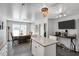Spacious kitchen features island seating, stainless appliances, and an adjacent dining area with a TV at 105 Walter Hagen Dr, Mebane, NC 27302