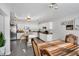 Open kitchen with stainless steel appliances, white cabinets, island seating, and an adjacent dining area at 105 Walter Hagen Dr, Mebane, NC 27302