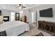 Spacious main bedroom with fireplace, tray ceiling, TV, and hardwood floors leading to an attached bathroom at 105 Walter Hagen Dr, Mebane, NC 27302