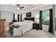 Comfortable main bedroom featuring a tray ceiling, an accent wall art piece, and large windows with natural light at 105 Walter Hagen Dr, Mebane, NC 27302