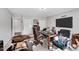 Well-lit home office featuring a large desk, comfortable chairs, and ample workspace at 105 Walter Hagen Dr, Mebane, NC 27302