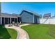 Landscaped backyard featuring a brick patio and seating area, complemented by lush green grass at 1108 Lowland St, Apex, NC 27523