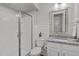 Modern bathroom featuring a glass-enclosed shower and a granite vanity with a stylish mirror at 1108 Lowland St, Apex, NC 27523