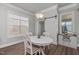 Cozy dining area featuring modern decor and a white sliding barn door at 1108 Lowland St, Apex, NC 27523