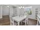 Bright dining room featuring wood floors, an elegant light fixture, and stylish decor at 1108 Lowland St, Apex, NC 27523