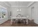 Elegant dining room featuring a coffered ceiling, stylish lighting, and beautiful wood floors at 1108 Lowland St, Apex, NC 27523