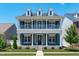 Beautiful two-story home with a covered front porch and well-manicured lawn on a sunny day at 1108 Lowland St, Apex, NC 27523