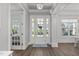Bright foyer showcasing hardwood floors, elegant lighting, and a welcoming entrance at 1108 Lowland St, Apex, NC 27523