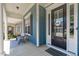 Charming front porch featuring a black front door, a cozy bench, and lovely neighborhood views at 1108 Lowland St, Apex, NC 27523