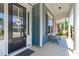 Inviting front porch with cozy seating, complemented by the home's blue siding and white trim at 1108 Lowland St, Apex, NC 27523