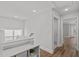 Well-lit upstairs hallway featuring a laundry closet at 1108 Lowland St, Apex, NC 27523