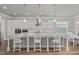 Spacious kitchen with a large center island, white cabinets, and modern stainless steel appliances at 1108 Lowland St, Apex, NC 27523