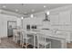 Bright kitchen features a large center island with bar stool seating and stainless steel appliances at 1108 Lowland St, Apex, NC 27523