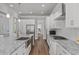 Gourmet kitchen with granite countertops, stainless steel appliances, and white cabinetry at 1108 Lowland St, Apex, NC 27523