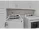 Convenient laundry room with a front loading washer and dryer and ample cabinet storage at 1108 Lowland St, Apex, NC 27523