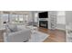 Comfortable living room with fireplace, large windows, and stylish decor at 1108 Lowland St, Apex, NC 27523