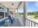 Inviting front porch with a blue Adirondack chair, white side table, and stately white columns at 1108 Lowland St, Apex, NC 27523