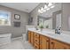 Bathroom with double vanity, framed mirrors, neutral color scheme and modern lighting at 112 Autumn Ridge Dr, Knightdale, NC 27545