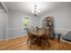 Bright dining area featuring hardwood floors, chandelier, and a large window at 112 Autumn Ridge Dr, Knightdale, NC 27545