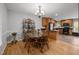 Cozy dining area with hardwood floors, chandelier, and decorative shelving, adjacent to the kitchen at 112 Autumn Ridge Dr, Knightdale, NC 27545