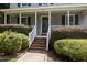 Inviting front porch with brick steps and lush landscaping surrounding the entrance at 112 Autumn Ridge Dr, Knightdale, NC 27545