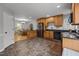 View of an open kitchen with wood cabinets, black appliances, and an adjacent dining area with natural lighting at 112 Autumn Ridge Dr, Knightdale, NC 27545